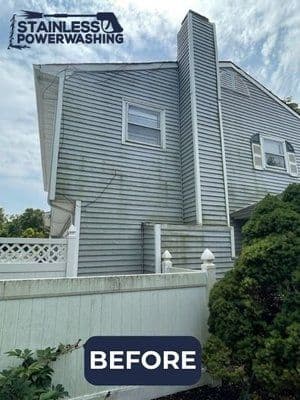 Before power washing, showing a weathered gray house with visible dirt and grime.
