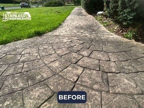 Before image of a stained, textured concrete sidewalk needing power washing.