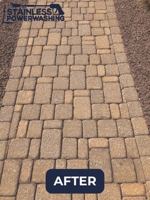 Clean and restored paved pathway with uniform bricks, showcasing professional power washing results.
